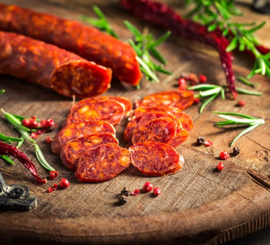 Sliced basque-style chorizo sausage on a wooden board